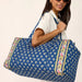 A blue duffel bag with a decorative floral print.