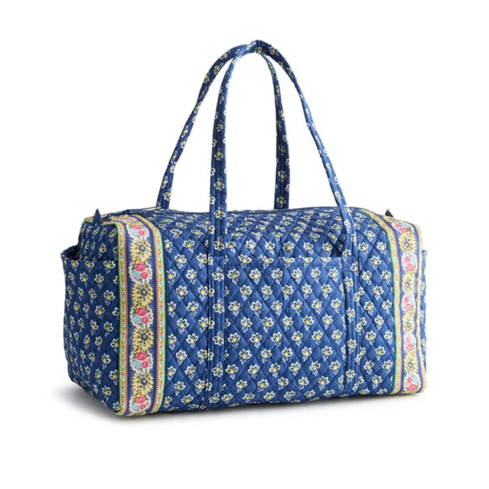 A blue duffel bag featuring a vibrant floral print design.