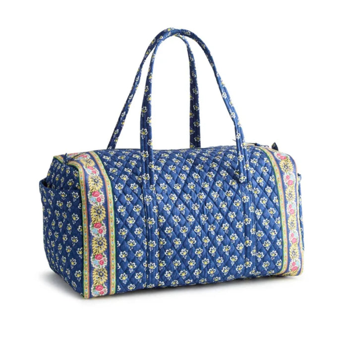 A blue duffel bag adorned with a colorful floral pattern.