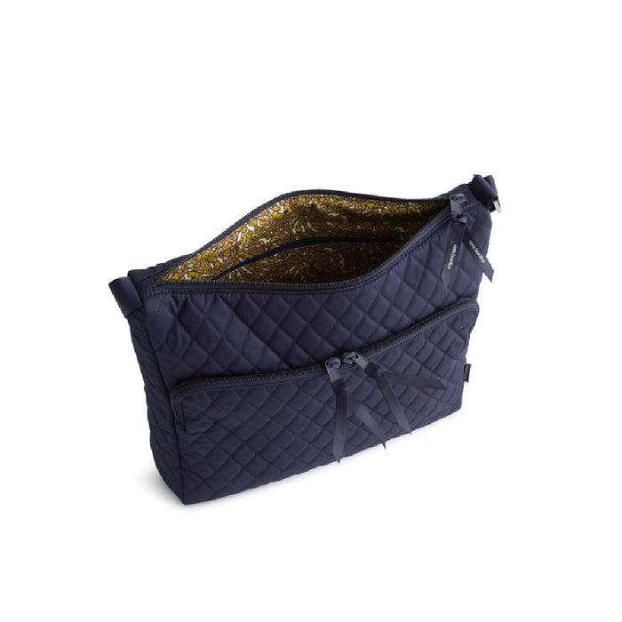 A navy blue quilted bag with a secure zipper.