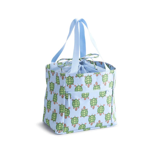 A blue tote bag featuring a turtle print and a matching blue handle.