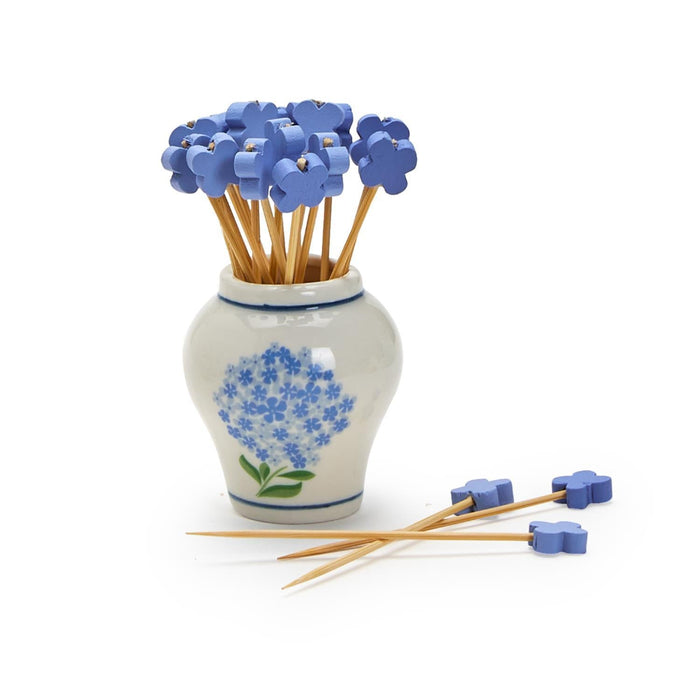 A stylish blue and white vase adorned with fresh blue flowers, creating a charming focal point in the arrangement.