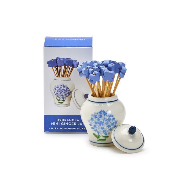 A compact jar with a blue and white color scheme, embellished with a flower motif.