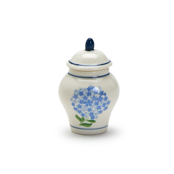 A decorative jar in blue and white, adorned with a floral pattern.