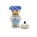 A blue and white vase filled with vibrant blue flowers, elegantly displayed against a neutral background.
