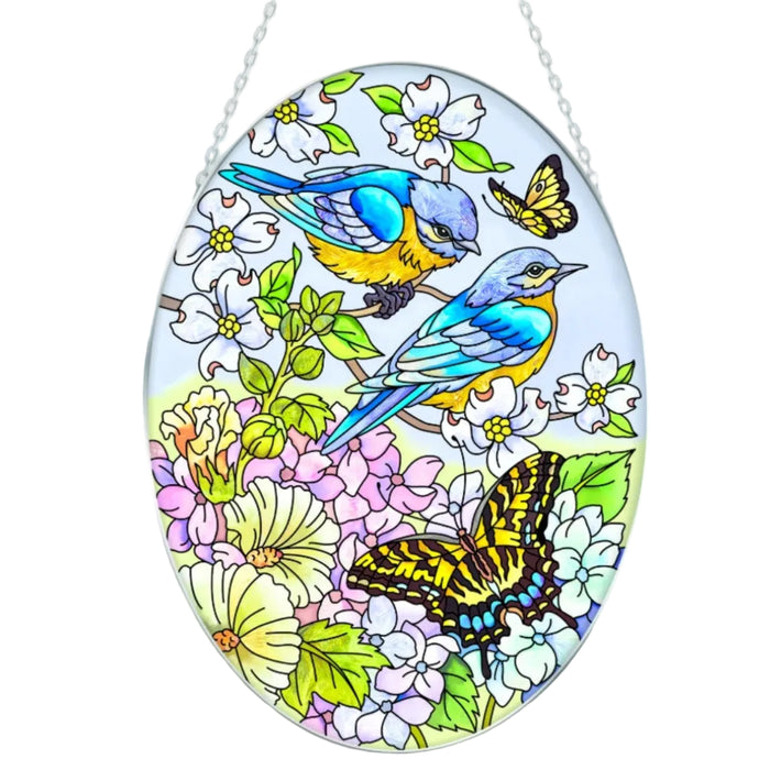 This Bridgeton Hall Blue Skies Bluebirds Medium Oval Suncatcher brings the peaceful beauty of bluebirds and open skies into your home décor. 