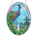 Bridgeton Hall Jewel of the Garden stained-glass-style suncatcher measuring 7 by 5.5 inches, featuring colorful jewel-toned flowers and garden-inspired artwork hanging in a sunny window.
