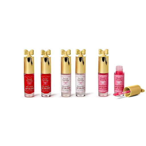 Set of lip glosses with gold caps on a white background
