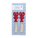 Two red lobster-shaped cutlery pieces rest on a striped tablecloth, adding a playful touch to the dining setting.