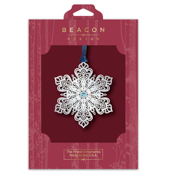 Decorative snowflake ornament in Beacon Design packaging on a white background