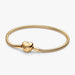 Gold-tone snake chain charm bracelet featuring a polished heart-shaped clasp on a white background, ideal for everyday wear and customizable with charms.