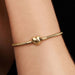 Gold-tone snake chain charm bracelet featuring a polished heart-shaped clasp on a white background, ideal for everyday wear and customizable with charms.