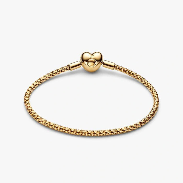 Gold-tone woven mesh chain bracelet with a polished heart-shaped clasp displayed on a white background, perfect for charms and everyday wear.