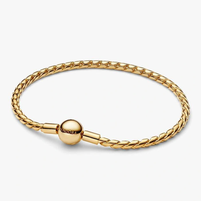 Gold-tone braided chain bracelet with a polished barrel clasp displayed on a white background, suitable for charms and everyday wear.