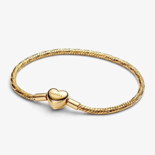 Gold-tone herringbone snake chain bracelet with a polished heart-shaped clasp designed for everyday wear and compatible with charms.