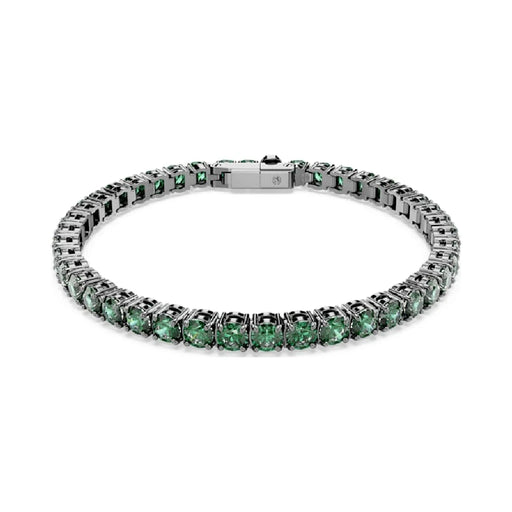 A delicate tennis bracelet adorned with vibrant emerald stones, showcasing elegance and luxury.