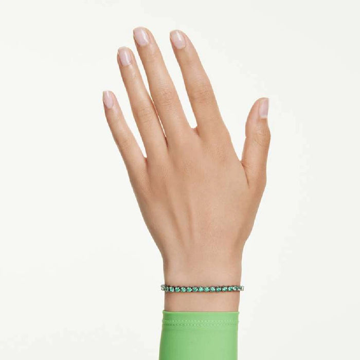 A beautiful tennis bracelet set with emerald stones, combining classic design with a touch of color.