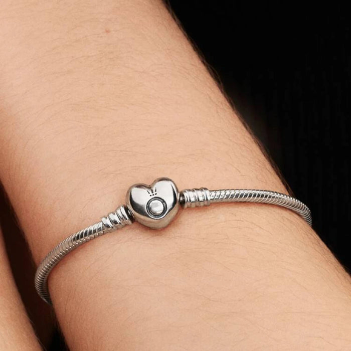 A silver bracelet embellished with a heart charm, ideal for expressing love and affection.