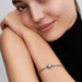 A refined silver bracelet with a heart charm, combining beauty and sentiment in its design.