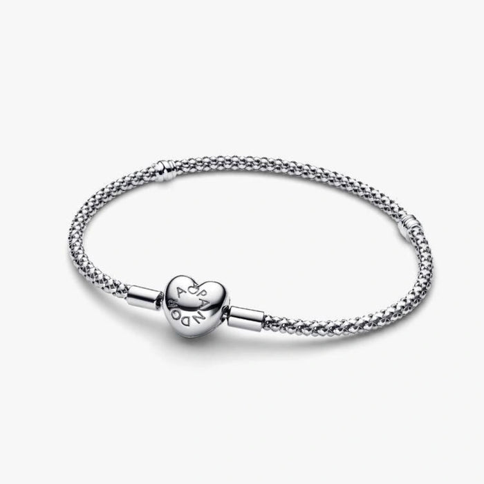Sterling silver mesh chain bracelet with a polished heart-shaped clasp designed for everyday wear and compatible with charm beads.