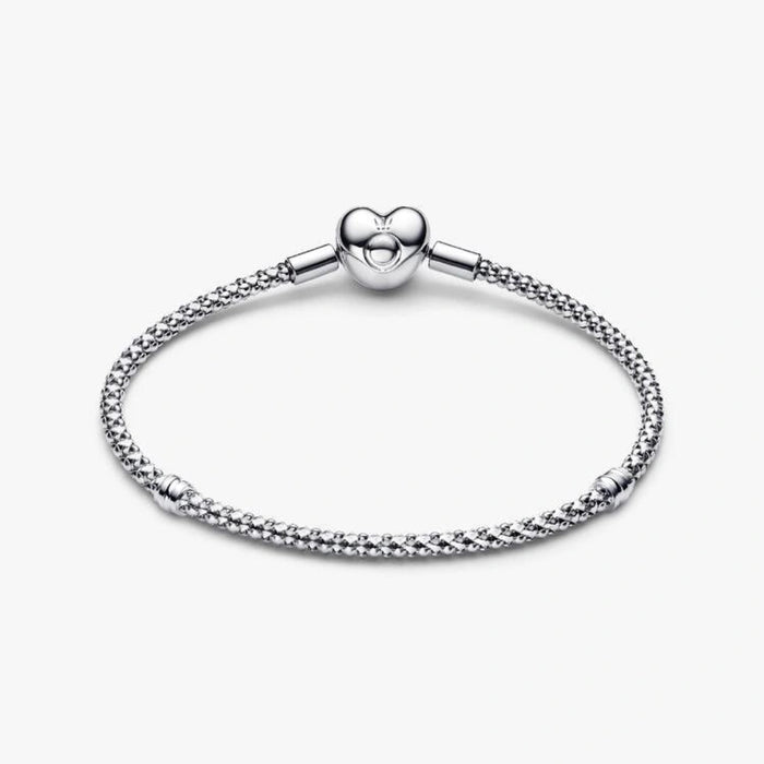 Sterling silver mesh chain bracelet with a polished heart-shaped clasp designed for everyday wear and compatible with charm beads.