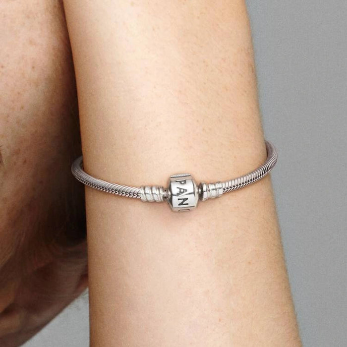 Sterling silver snake chain bracelet with a polished square clasp compatible with charm beads and designed for everyday wear.