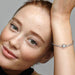 Sterling silver snake chain bracelet with a polished square clasp compatible with charm beads and designed for everyday wear.