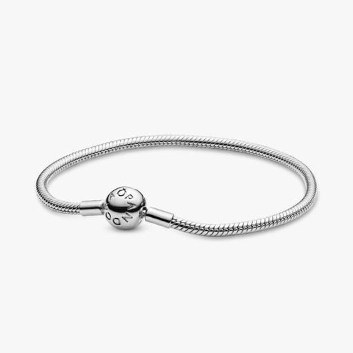 Sterling silver snake chain bracelet with a polished barrel clasp displayed on a white background, designed for everyday wear and compatible with charm beads.