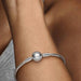 Sterling silver snake chain bracelet with a polished barrel clasp displayed on a white background, designed for everyday wear and compatible with charm beads.