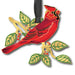 Red cardinal bird ornament with green leaves on a white background