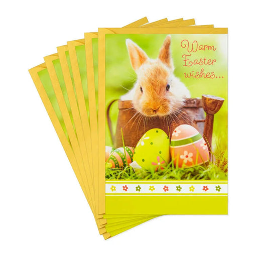 Stack of Easter cards with a rabbit and eggs design on a white background
