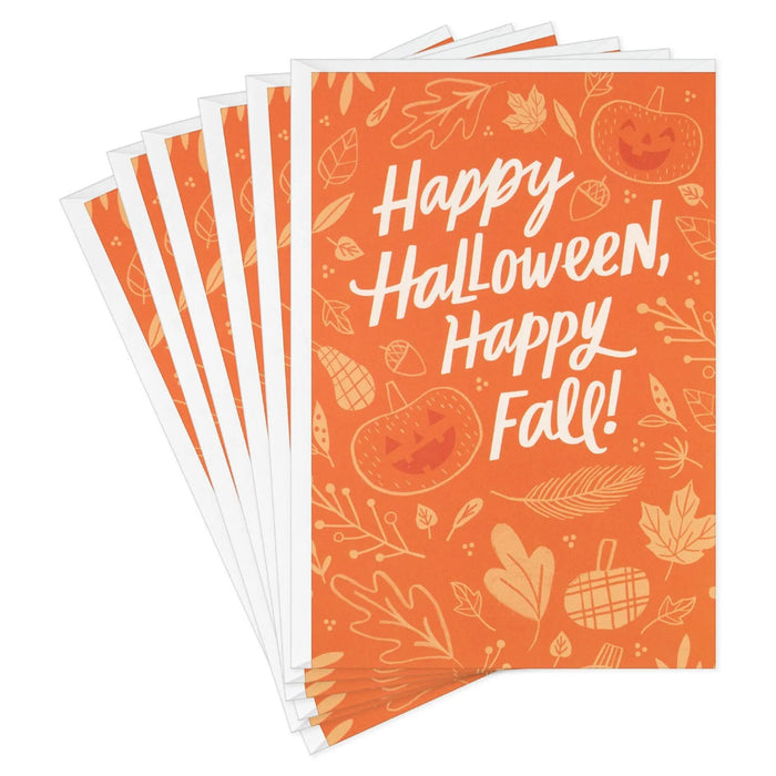 Front of Hallmark Halloween card featuring jack-o'-lanterns, pumpkins, fall leaves, and gourds on an orange background