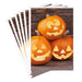 Hallmark Jack-o'-Lantern Trio Halloween card featuring three smiling pumpkins on a rustic wood-plank background.