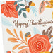 Thanksgiving greeting card featuring a harvest pumpkin, colorful autumn leaves, and floral accents for seasonal celebrations.