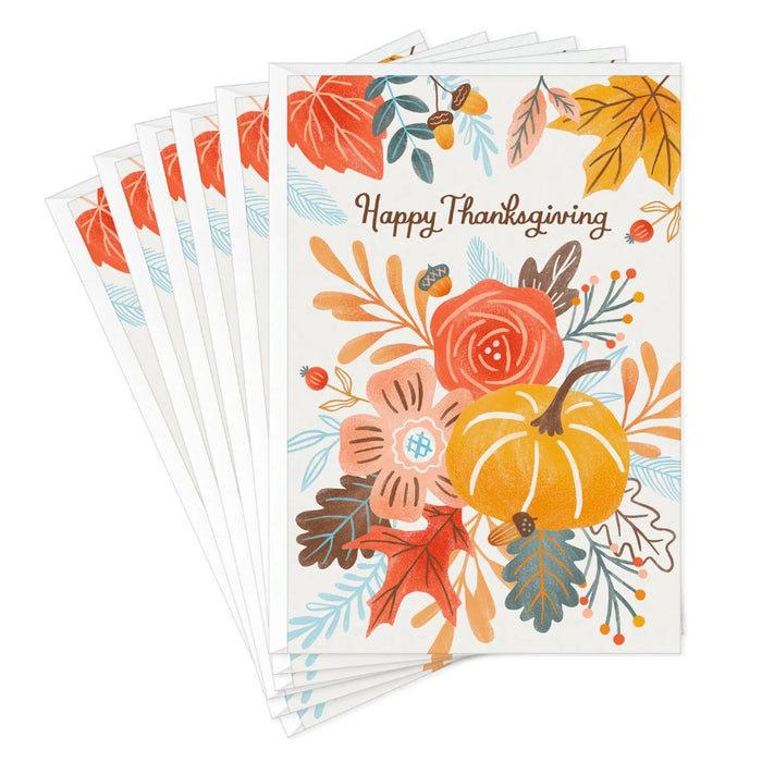 Thanksgiving greeting card featuring a harvest pumpkin, colorful autumn leaves, and floral accents for seasonal celebrations.