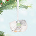 Decorative Holiday ornament with a polar bear and penguin snuggling, hanging on a Christmas Tree 