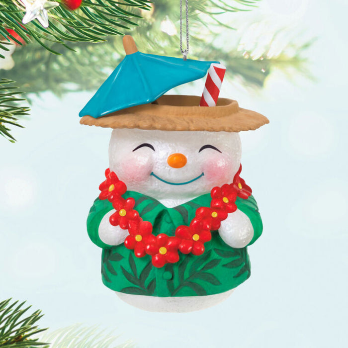 Snowman Beach Drink ornament with a beach hat, umbrella, and lei , hanging on a tree