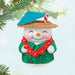 Snowman Beach Drink ornament with a beach hat, umbrella, and lei , hanging on a tree