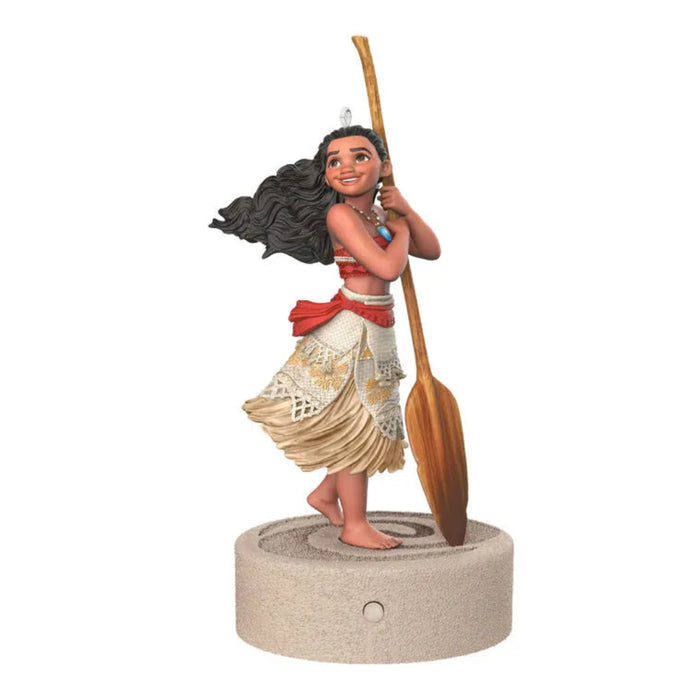 Three-quarter view of Moana ornament featuring red sash, blue pendant necklace, and lace trim