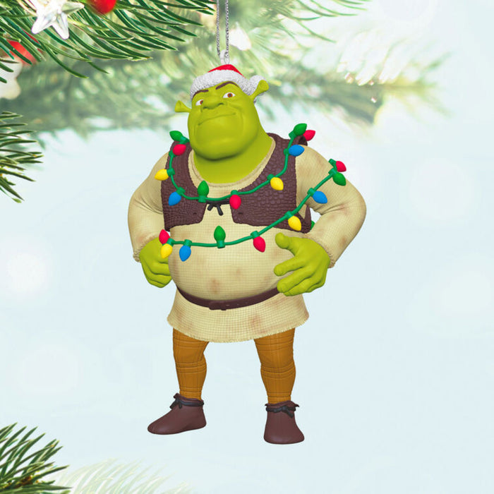 Shrek ornament with Christmas lights on his body, hanging form a tree