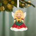 Red and white angel Christmas tree ornament hanging on pine branch