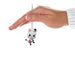 Hand holding a Mini Gabby's Dollhouse Pandy Paws Ornament, pink and black cat with a pink stripped handbag against a white background