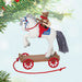 Christmas ornament of  a horse on a  cart, featuring a bear rider playing a guitar hanging on a Christmas tree.