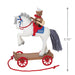Christmas ornament of  a horse on a  cart, featuring a bear rider playing a guitar on a white background with product dimensions. 
