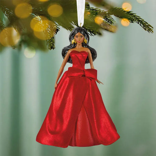 Front View: 2026 Hallmark Keepsake Latina Holiday Barbie Christmas Ornament wearing an elegant festive gown hanging on a festive tree  