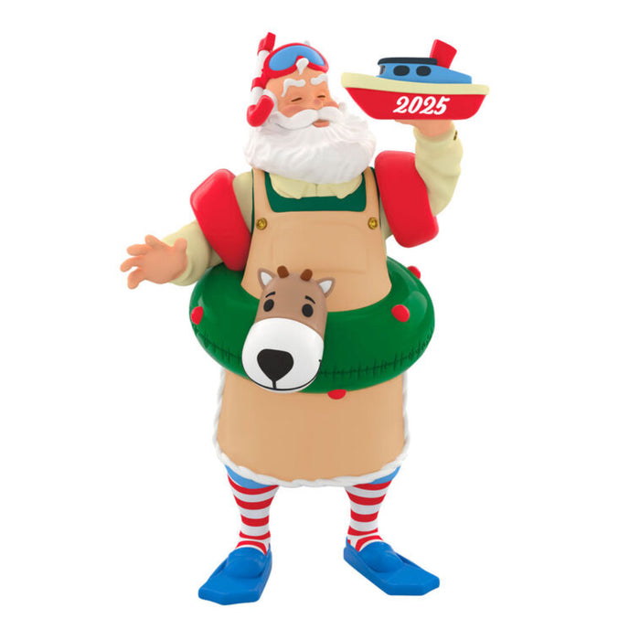 Decorative Holiday  ornament of a Santa Claus figure with a reindeer floatie, holding a boat labeled '2025'.