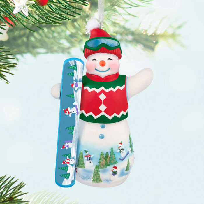 2025 Hallmark snowman ornament with goggles, hat, and sweater vest with a  snow board; hanging on a tree.  part of the Snowtop Lodge series.