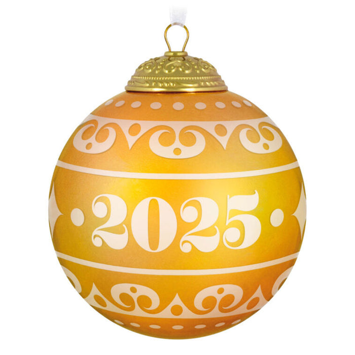 Decorative warm yellow Christmas glass ball ornament with year '2025', on a white background 