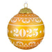 Decorative warm yellow Christmas glass ball ornament with year '2025', on a white background 