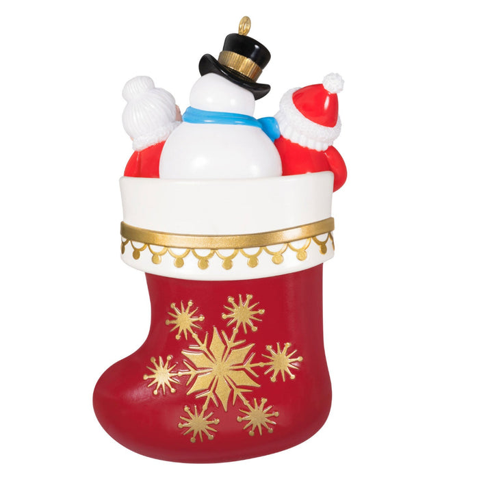  Backside of the Christmas ornament with Santa, snowman, and reindeer on a red stocking with gold snowflakes. on a white background 